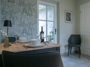 a table with a bottle of wine and a glass at Moserhof in Wahlhausen