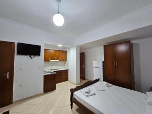 a large room with a bed and a kitchen at Guest House Bledar in Ksamil +33 photos