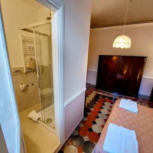 a bathroom with a shower with a glass door at Residenza Maritti Decò Style in Rome