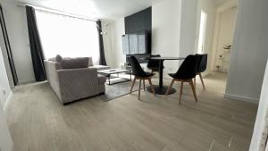 a living room with a couch and a table and chairs at Appartement hyper centre - Coty in Le Havre