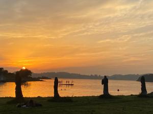 een groep mensen die bij zonsondergang op het strand staan bij Mettes Cave in Sola