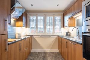 a kitchen with wooden cabinets and a window at Apartment 91 in Inverness