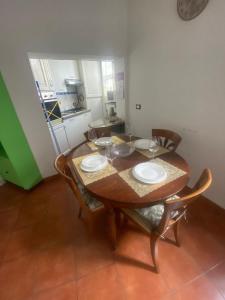 a wooden table with chairs and plates on it at Morgagnigd in Florence