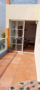 a patio with a view of a room with a window at Estacion 42 in Puerto Nuevo