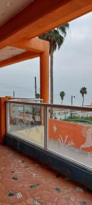 a balcony with a view of the ocean and a palm tree at Estacion 42 in Puerto Nuevo