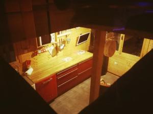 an overhead view of a kitchen with wooden cabinets at Chalet California Dreamin Route 66 in Casteil +43 photos