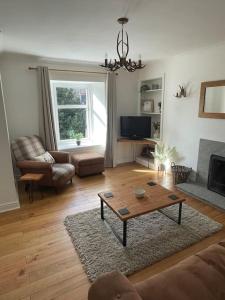 a living room with a couch and a coffee table at Daisy Cottagee in Alyth