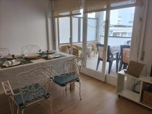 a dining room with a table and chairs and a balcony at 3 Bed Flat - Sleeps 5 - Wifi in Bellreguart +4 photos