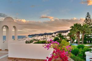 a view of a town with white buildings and pink flowers at Mojácar Vibes 1 Línea de Playa in Mojácar