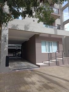 a building with a ramp leading into a garage at Departamento Del Valle in Tandil