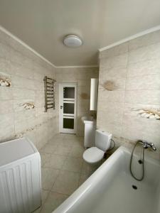 a bathroom with a tub and a toilet and a sink at Новобуд.Стрийська,Ашан,Сихів,Автовокзал in Lviv +7 photos