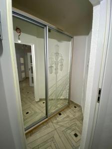 a glass door in a room with a wooden floor at Новобуд.Стрийська,Ашан,Сихів,Автовокзал in Lviv
