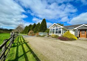 a house with a fence on the side of a road at Lackandarralodge large 5BR entire house sleeps14! in Dungarvan