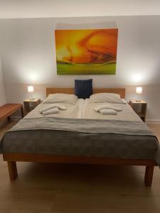 1 dormitorio con 1 cama grande y una pintura en la pared en Bavaria Wirtshaus - Hotel & Gästezimmer- Frankenberg Eder en Frankenberg