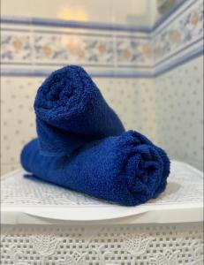 a blue towel sitting on top of a white plate at Aurora Apartment in Żurrieq