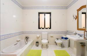 a bathroom with a tub and a toilet and a sink at Aurora Apartment in Żurrieq