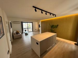 un salon avec une table et un mur jaune dans l'établissement Modern 2bed in the centre, à Nicosie