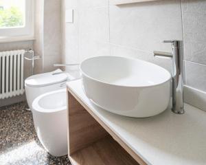 a white bathroom with a sink and a toilet at 051 - Villa Genny Appartamento Agrumi in Sestri Levante