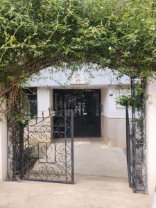 an entrance to a building with a black gate at tuna doğa evi in Balcova