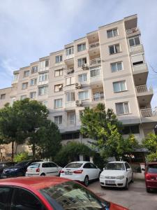 a large building with cars parked in front of it at tuna doğa evi in Balcova