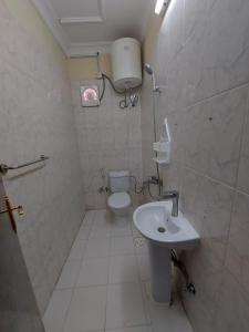 a small bathroom with a toilet and a sink at Jawad Al Dham in Medina