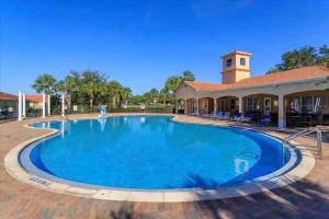 a large pool in front of a building at Home with amenities - Family vacation in Orlando in Kissimmee