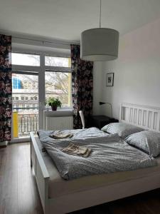 a bedroom with a bed and a large window at Rodinný apartmán neďaleko centra in Banská Bystrica