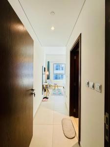 a hallway with a door leading to a living room at Modern Room With Attached Bathroom Near Rigga Metro & Close to Airport in Dubai