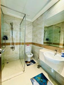 a bathroom with a shower and a toilet and a sink at Modern Room With Attached Bathroom Near Rigga Metro & Close to Airport in Dubai