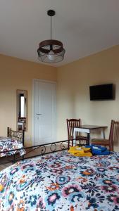 a room with a bed and a table with a rug at Al Vecchio Lavatoio in Colle Brianza