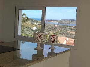two vases sitting on a window sill with a view at Villa Ginepro in Olbia