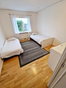 מיטה או מיטות בחדר ב-Stort hus uthyres med utegård gräsmatta