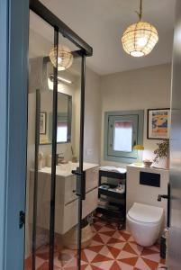a bathroom with a toilet and a sink at La Niña de Vejer in Vejer de la Frontera