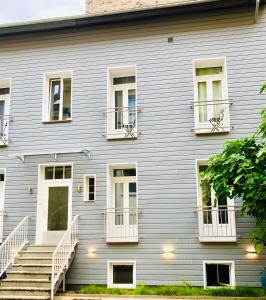 a gray building with white balconies and stairs at Living at Saarpartments -Adults Only- Business & Holiday Apartments with Netflix for Long- and Short term Stay, 3 min to St Johanner Markt and Points of Interest in Saarbrücken