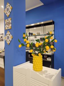 a vase filled with oranges on top of a table at Kristal in Cinisi