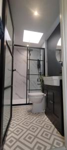 a bathroom with a toilet and a sink at The Nook: Self Contained Annex in Taunton