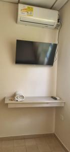 a shelf in a room with a heater on a wall at Hotel Almirante Padilla in Ríohacha +34 photos