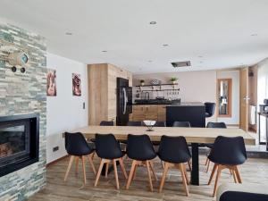 a kitchen and dining room with a table and chairs at les piafs du der 1 in Joncreuil +87 photos