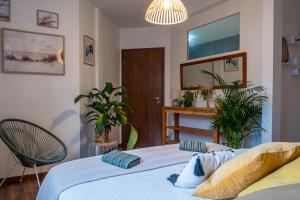 a bedroom with a bed and a mirror and plants at Appartement Standing piscine intérieur privatisée . in Mutzig