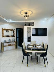 a dining room with a table and chairs at Luxury Apartment with swimming pool in El Jadida