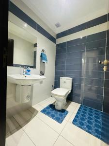 a bathroom with a toilet and a sink and a shower at Luxury Apartment with swimming pool in El Jadida