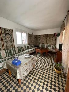 a living room with a couch and a table at Dar Mora in Tangier