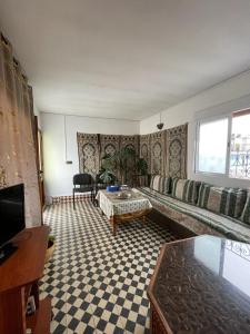 a living room with a couch and a table at Dar Mora in Tangier