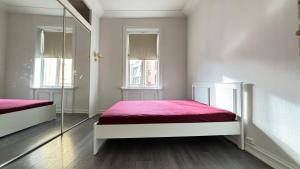 a bedroom with two beds and a mirror at Oslo-Frogner in Oslo