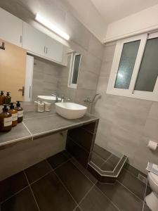 a bathroom with a white sink on a counter at Cute studio near acropolis in Athens +13 photos