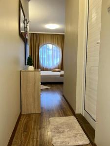 a hallway with a room with a bed and a table at Hotel Silver in Sozopol
