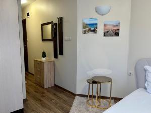 a bedroom with a bed and two stools at Hotel Silver in Sozopol