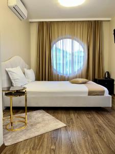 a bedroom with a bed and a window at Hotel Silver in Sozopol