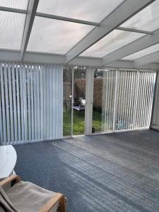 a screened in porch with sliding glass doors at Rådhus in Bara