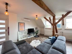 a living room with a couch and a tv at Vila Stela BOJNICE in Bojnice